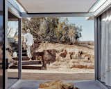 Outdoor, Small Patio, Porch, Deck, and Concrete Patio, Porch, Deck A view out from the entrance lobby shows Koch leaving the house. He made the stairs' steel risers himself, with the help of his cousin, Chris Wilson.  Photo 9 of 9 in iT House, Joshua Tree