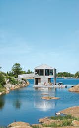 Cedar slats mark the facade of the Worple's lakefront vacation home in Ontario.