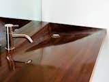 A high-gloss iroko-wood sink in the sleeping cabin's bathroom, designed by architecture students at the University of Toronto.  Photo 5 of 16 in A Floating House on Lake Huron Stands Out By Blending In