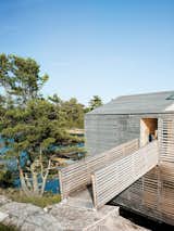 Exterior, Wood Siding Material, and House Building Type A footbridge connects the Floating House to the island.  Search “floating-pool.html” from A Floating House on Lake Huron Stands Out By Blending In