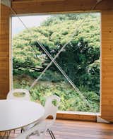 A huge window next to the dining area is punctuated by a steel X form.  Photo 5 of 9 in Lava Flow 4, The Big Island