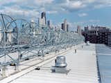 A horizon-line of rooftop wind turbines turns the skies of the Windy City into an omnipresent source of electrical power. Installed by the Chicago-based firm Aerotecture International, the turbines give the building both a steady supply of power and a distinct appearance, visible from several blocks away.  Photo 3 of 8 in Inside Chicago’s Helmut Jahn–Designed Supportive Housing Development