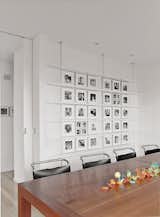 In the dining room, Mies van der Rohe chairs surround a custom-made cherry table. Black-and-white photographs of Sasseen's children and grandchildren are arranged systematically on the back wall.  Search “be+my+girlfriend是什么意思中文翻译【精+仿++微wxmpscp】” from Bauhaus by the Sea