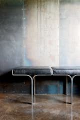 An aluminum bench harmonizes with the industrial nature of the galvanized-steel walls and the polished concrete floor.