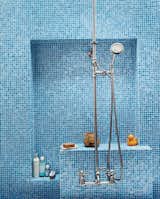 The bathroom glows with various shades of Turkish-style glass tiles (in Iris) from Galleria Tile in San Francisco; the custom nickel-plated hardware is from Chicago Faucets.