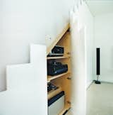 In keeping with the maxim “a place for everything and everything in its place,” 

any A/V equipment that does not need to be on show is hidden away in these neat push-to-open cupboards beneath the stairs. This means that you’d never spy 

an unsightly trailing power cable cluttering up the compact space.