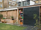 Out in the garden, Lee designed a large cupboard with a sliding door and bank of shelves.  Photo 7 of 8 in Slanted and Enchanted