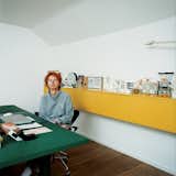 Nina Tolstrup sits at her dining table/office space.  Photo 1 of 28 in Inside the Workspaces of Creatives by Aileen Kwun from A Mama's Touch
