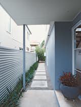 Side Yard, Hardscapes, Metal Fences, Wall, Horizontal Fences, Wall, and Outdoor Clayden made the most of his modest lot by building as close to the perimeter as local zoning codes allow.  Photos from Minimalist Bachelor Pad in Brisbane