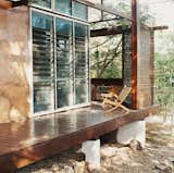 Slatted wooden screens afford privacy and break the short but driving rains that blast the house from the southwest.