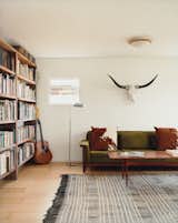 Living Room, Light Hardwood Floor, and Sofa Siegal built bookshelves from scrap wood, bartered for her Danish modern furniture, and haggled for a living-room rug in Morocco.  Photo 3 of 7 in Rugs by Michael Seelhof from Method Lab