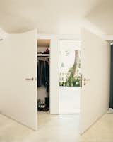 Oversize doors in the front entry create the sense of continuous wall when closed.