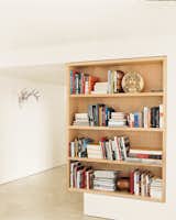 A maple bookcase defines the point between the living room and foyer.