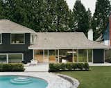 After trying dozens of colors, LeBlanc says, they settled on basic black for the exterior as a way to best marry the building with its forest surroundings, which include 30-foot-high western red cedar trees. The pool is original; but the deck, once made of concrete, has been reclad in granite to match the old retaining wall.