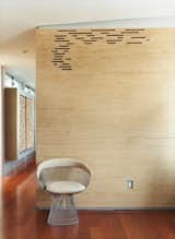 Stacked Baltic birch plywood strips encase the master bathroom, with gaps providing ventilation.