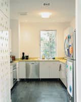 The kitchen is IKEA; the floors, like those in the bathroom, are Brazilian slate.