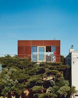 Exterior, House Building Type, and Metal Roof Material A 24-by24-foot Cor-ten-clad pavilion tops the three-story addition.  Search “three-buildings-mitchell-joachim.html” from This Surfer's Beach House is More Than It Seems