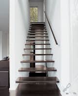 Interior wood stairs are pared with a top-floor steel staircase outside.
