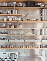 The kitchen shelves are organized with clinical precision.