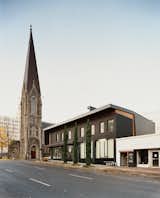 Referencing the First Presbyterian Church’s slate roof, 12 + Alder makes nice to its divine neighbor.