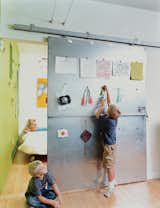 David Baird designed the custom sliding doors with materials and hardware from Home Depot. The doors also act as a makeshift critique wall for Bo and Sky’s artwork.