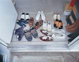 Friends from Tokyo are touring the house. Their miscellaneous footwear litters the entranceway of three-story Unit F.