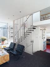 A floating steel staircase ties the living area and loft together. Variegated steel tubes provide graphic punch while maintaining the apartment’s airy and open feeling.