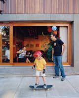 Resident Brooks Jordan and his son Leif take some time out to play outside the Belmont, where a steady stream of pedestrians and diners lend the building an inviting feel.  Photo 8 of 10 in Community Building