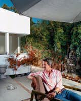 The front, middle, and rear yards are conceived as outdoor rooms. Pierre Kozely relaxes 

in the middle yard in a prototype of an outdoor furniture line by Pietrarte. A bronze Ganesh is on a raised pedestal in the middle of a small water feature.