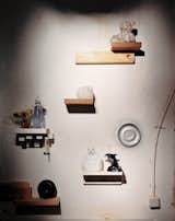 An installation of mismatched handmade shelves makes a display area for another enigmatic assortment of objects, including a Wanders Sponge vase (1997), made by soaking a real sponge in clay, which burns away when the piece is fired. The same technique was used on the silver-plated teddy bear above it. The dolphin and Buddha figures—perhaps a reminder of Wanders’s role in mainstreaming kitsch—illustrate the designer’s interest in ordinary, popular decorative objects.