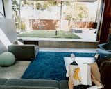 The living room flows effortlessly out to the courtyard. This unity is underscored by the living room’s blue shag rug from the Shag Rug Company.  Photo 1 of 8 in Solar Inspiration