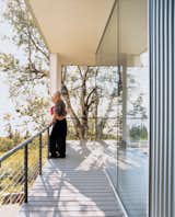 Outdoor, Wood Patio, Porch, Deck, and Small Patio, Porch, Deck The whole house opens up to its surroundings with floor-to-ceiling windows that are perfect for nature gazing.  Photo 2 of 9 in Alaska: The Final (Architectural) Frontier