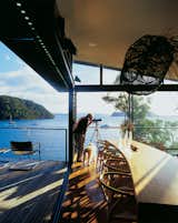 Dougal James-Robertson studies the expansive views that extend all the way to the Barrenjoey headland many miles away with the use of a handy telescope. The sliding glass wall makes the kitchen feel like an outdoor room.