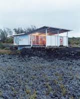 Exterior, House Building Type, Mid-Century Building Type, Shed RoofLine, Wood Siding Material, Metal Roof Material, Flat RoofLine, and Glass Siding Material For an escape from bustling San Francisco, architect Craig Steely and his wife Cathy have created a modernist getaway on a lava field next to a black sand beach on Hawaii’s Big Island. Fitted with floor-to-ceiling windows that look out over the ocean, the steel-framed home is one of several homes that Steely built on the recently active lava field.  Photo 4 of 7 in Incredible Island Houses Part One by Erika Heet from Go With the Flow