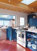 Primary colors and uncomplicated spaces define the interiors of both sheds. Golob is shown above in the modest open kitchen, where appliances were chosen for “cost, durability, and efficiency.”  Photo 7 of 10 in Off the Beaten Path