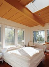 Skylights and huge windows flood the master bedroom—and every room in the house—with sunlight. Bed by Techline; lighting by Tech Lighting.