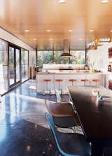 “It was a major decision to put the kitchen in the center where everything would revolve around it,” says Lazor. “We did this simply by following what patterns we observed—it was just where people gravitated.” The bar stools are by Blu Dot, and the chairs by Charles and Ray Eames.