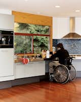 Meal prep is simplified for Siple. All the cabinets are easy to open, there’s space under the cooktop for his wheelchair, and a faucet over the range removes the need to haul pots to the sink for filling.