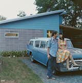 Andy and Regina Rihn lean on their other blue-clad affordable design, a 1958 AMC Rambler Super station wagon, in front of their house in Austin, Texas.