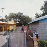 Andy and Regina greet their neighbor Dan Morris, owner of the Beckham-designed house.