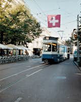 A tram rumbles down Bahnhofstrasse, a popular and tony shopping district where private banks, watch stores, boutiques, and chocolatiers line the renowned thoroughfare.