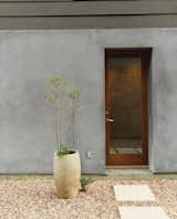 Designers Matt and Tina Ford created the concrete planters that dot the gravel courtyard. &nbsp;
