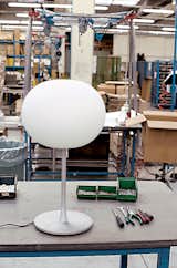 After the electrical components are installed, the globe is affixed to the base, and a Flos Glo-Ball is completed and ready for purchase. Since the design debuted in 1999, it has surpassed the Arco as the company's best selling series of lamps.
