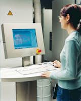 A technician at EOS works with Kyttänen's designs on a Selective Laser Sintering machine. Before they can be implemented, his designs must be run through slicing software that divides the digitized blueprints into some 6,000 horizontal cross-sections.