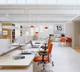 Vitra's world headquarters, designed by the Bouroullec brothers, are made to adapt, with expandable suspended screens and a raised open desk system.  Photo 1 of 1 in Vitra