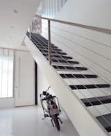The home’s entryway features fly-ash concrete floors and stairs cut from recycled steel.