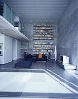 The cavernous living room takes advantage of its height with floor-to-ceiling bookshelves.