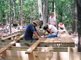 Students lay down cedar planks in preparation for the amphitheater.  Photo 5 of 6 in Camp Counsel