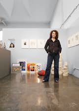 Jennifer Strate O’Neal stands in front of a print portfolio from 1985. The Diana Ross bust is by William Scott, whose self-portrait is on the floor, among works by Angela Archuleta, Dan Miller, and Donald Mitchell. The soft sculpture is by Judith Scott and the clay forms are by Charles Nagle.  Photo 1 of 4 in Art Start
