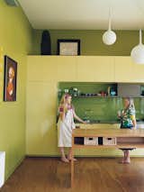 The eye-catching kitchen cabinets behind Cat Macleod and her daughter, Celeste, were custom-built in lemon Liri Laminate by Amerind. The island bench is made from the same alpine ash used on the floor and the stairs all the way up to the master bedroom. Read the full article here.  Photo 6 of 7 in Bellemo & Cat's Cradle
